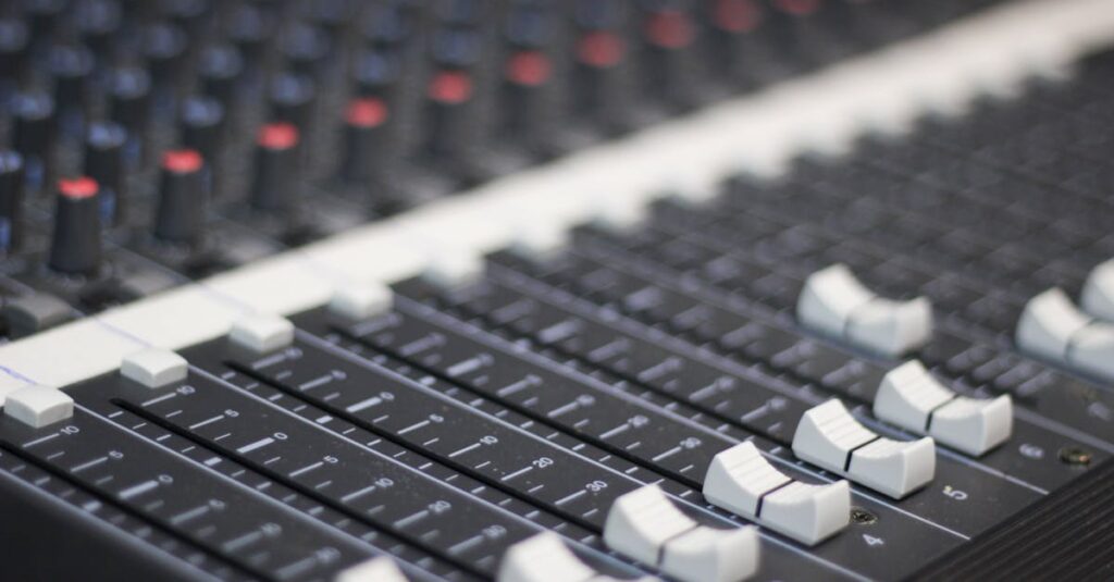 Detailed view of a sound mixer panel with sliders and knobs for audio control.