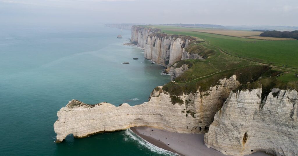 Drone shot capturing the stunning cliffs and coastline of Etretat, Normandy.